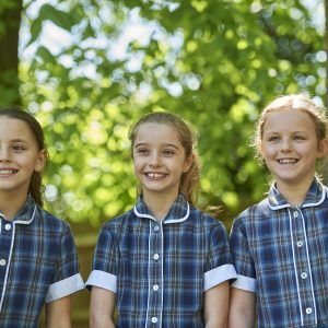 three girls stood in their uniform