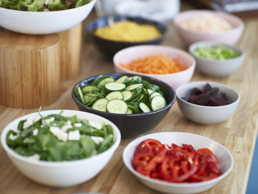 plates of chopped vegetables for salads