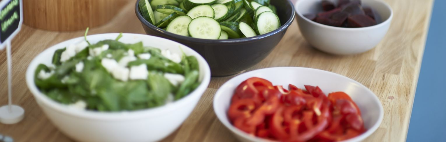 plates of chopped vegetables for salads