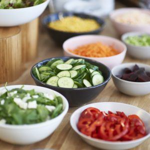 plates of chopped vegetables for salads