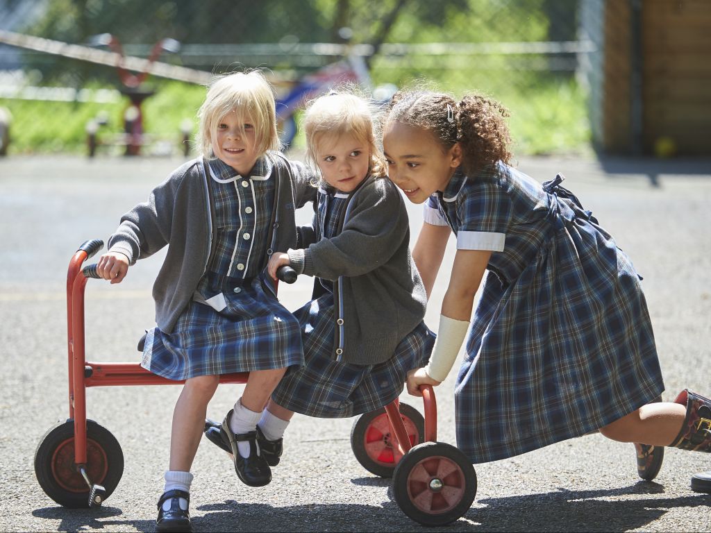 children being pushed on a bike