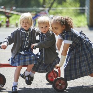 children being pushed on a bike