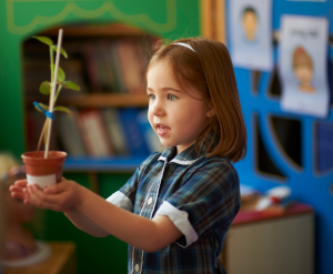 girl holding a plant